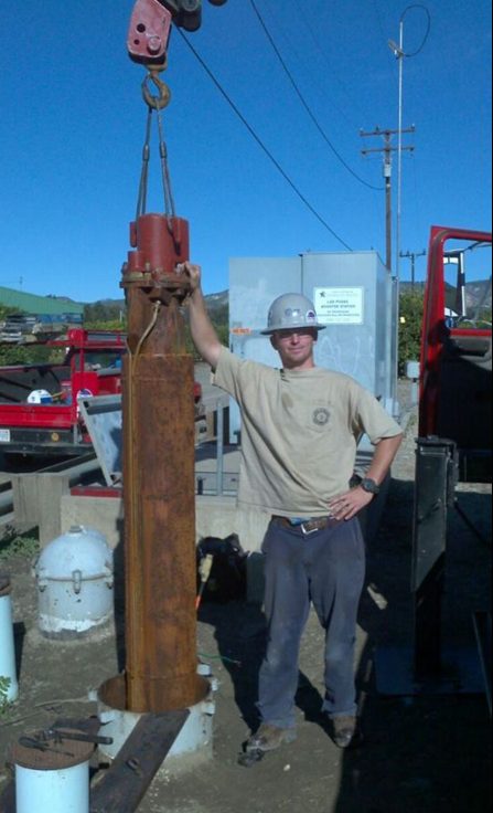 OEC technician on an oil field job site with downhole pump equipment